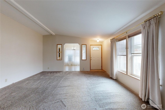 interior space with lofted ceiling, carpet floors, and plenty of natural light