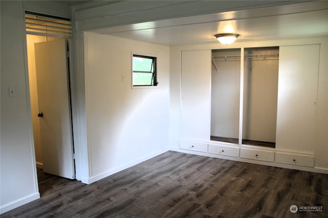 unfurnished bedroom featuring dark hardwood / wood-style flooring