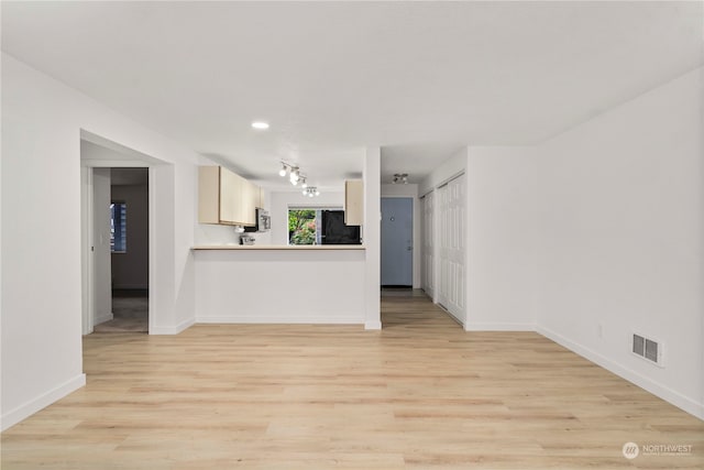 interior space featuring black fridge and light wood-type flooring