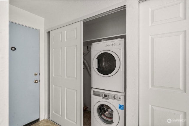 laundry area with stacked washing maching and dryer and laundry area