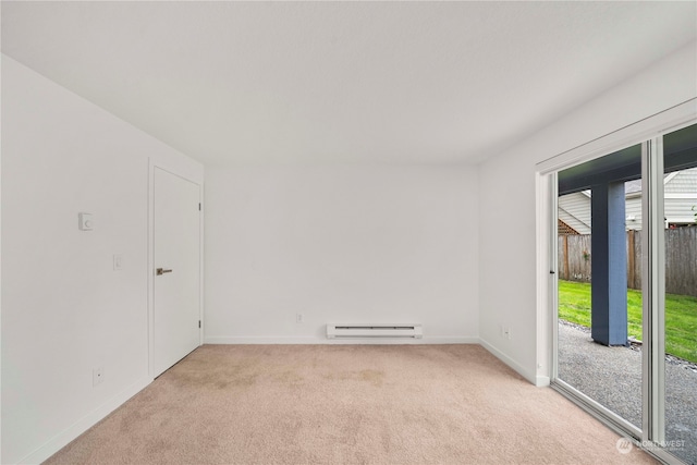 carpeted empty room with baseboard heating