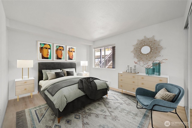 bedroom with wood finished floors and baseboards
