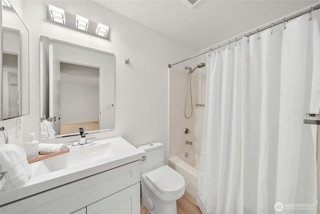 full bath featuring toilet, shower / bath combination with curtain, and vanity
