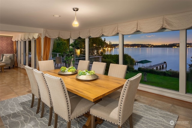 tiled dining space with a water view