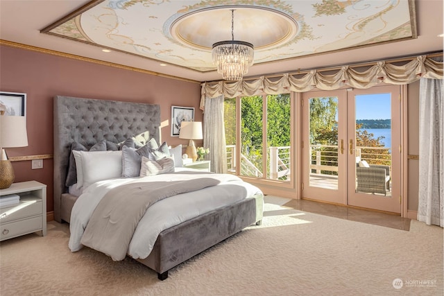 carpeted bedroom featuring access to outside, a water view, ornamental molding, and an inviting chandelier