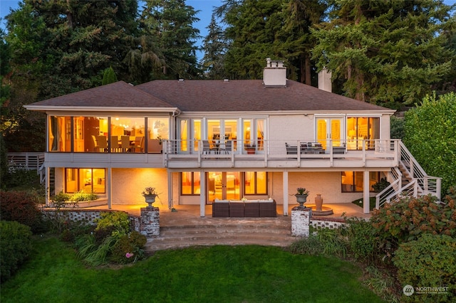 back of property with a patio, a yard, french doors, and an outdoor hangout area