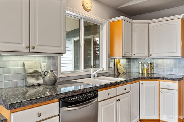 kitchen with decorative backsplash, stainless steel dishwasher, sink, and white cabinets