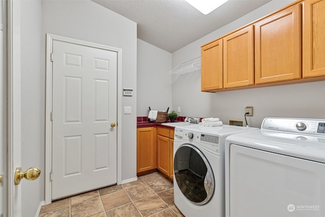 laundry room with a textured ceiling, washer and clothes dryer, sink, and cabinets