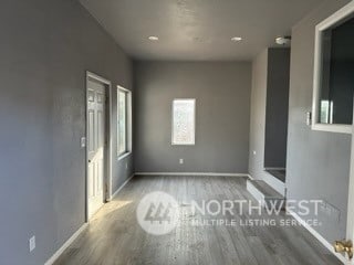 empty room with hardwood / wood-style floors