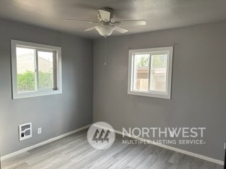 unfurnished room with ceiling fan, a healthy amount of sunlight, and light hardwood / wood-style flooring