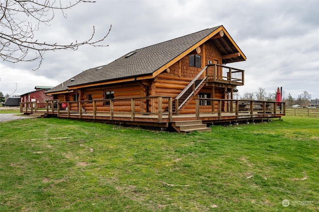 rear view of property with a lawn and a deck