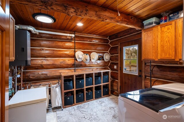 laundry room with separate washer and dryer, cabinets, rustic walls, and wooden ceiling