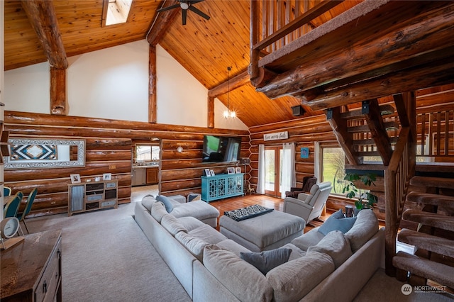 living room featuring wood ceiling, high vaulted ceiling, beamed ceiling, ceiling fan, and rustic walls