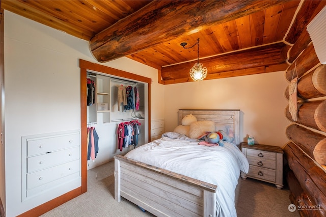 carpeted bedroom featuring a closet, beam ceiling, and wooden ceiling