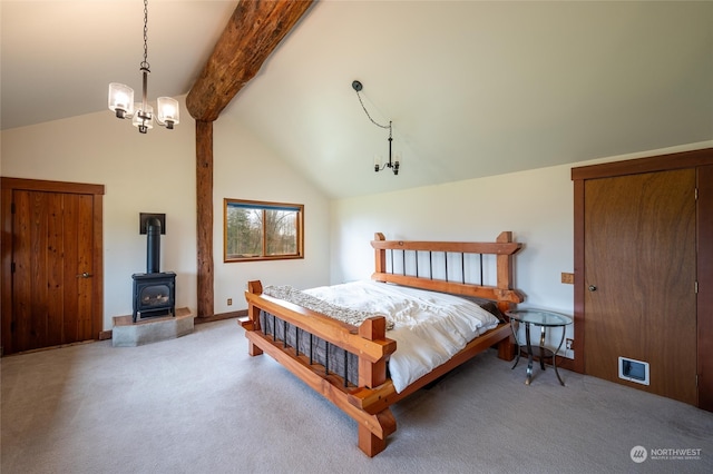 bedroom featuring beam ceiling, a wood stove, a chandelier, high vaulted ceiling, and light colored carpet