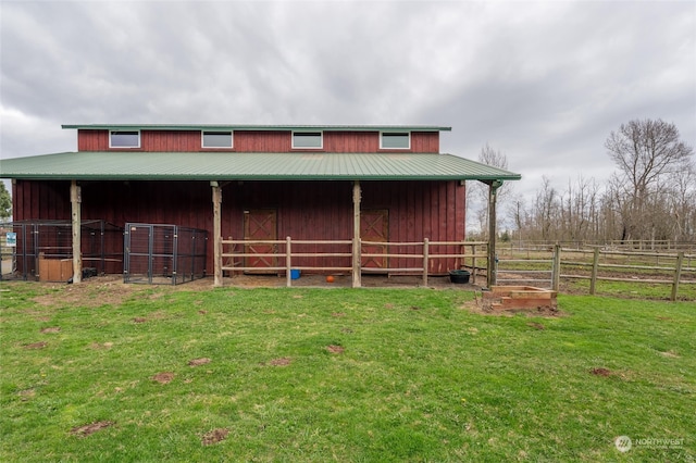 back of house with an outbuilding