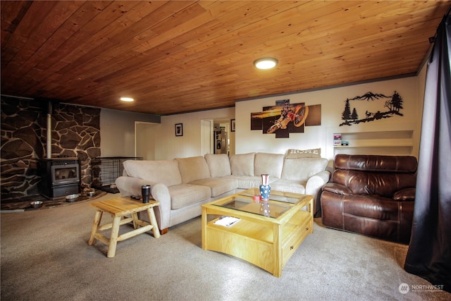 carpeted living room featuring a wood stove and wood ceiling