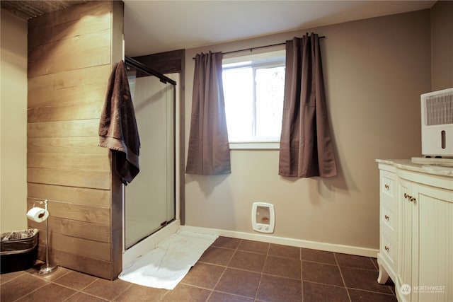 bathroom featuring vanity, tile patterned floors, and a shower with shower door