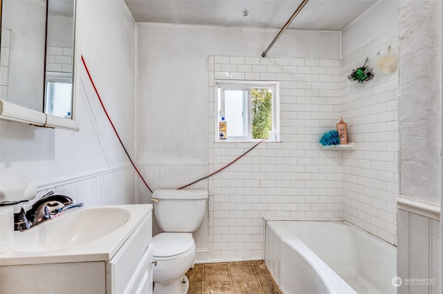 full bathroom featuring tiled shower / bath combo, tile patterned flooring, vanity, and toilet