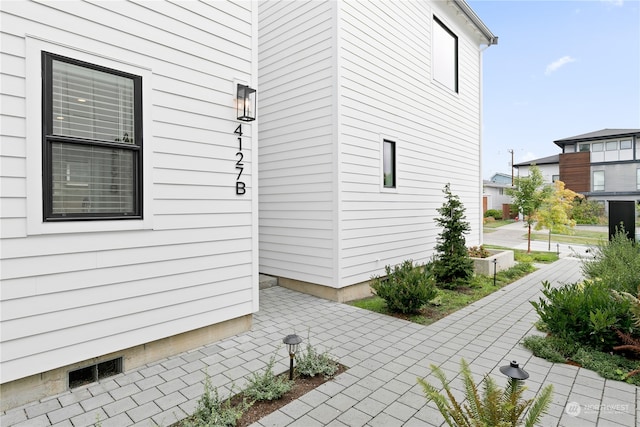 view of side of property with a patio area