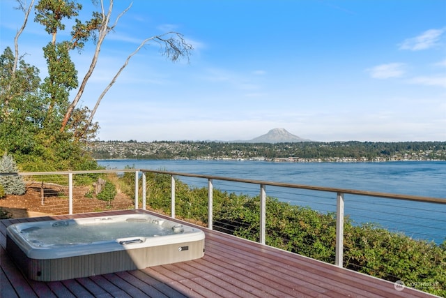 wooden terrace with a water and mountain view