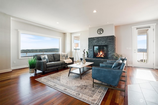 living room with a water view, a healthy amount of sunlight, and wood-type flooring