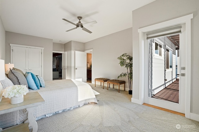 carpeted bedroom with access to exterior, a closet, ceiling fan, and ensuite bathroom