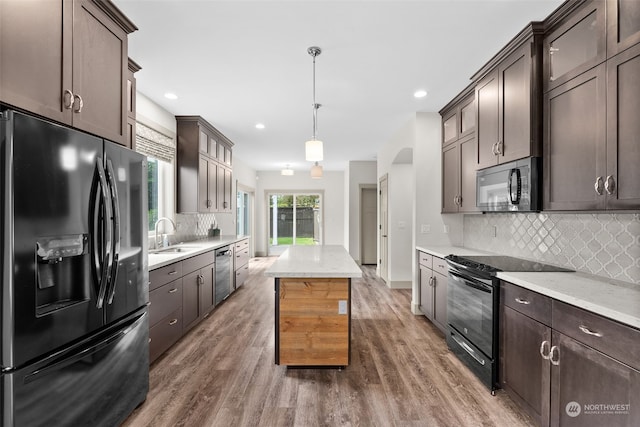120 E 52nd St, Tacoma, WA 98404 - kitchen featuring pendant lighting, sink, dark wood-type flooring, and black appliances
