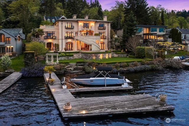 dock area featuring a water view and a balcony