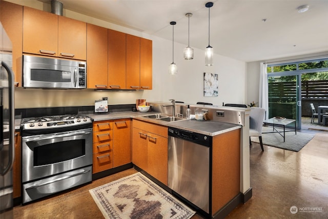 kitchen featuring pendant lighting, appliances with stainless steel finishes, sink, and kitchen peninsula