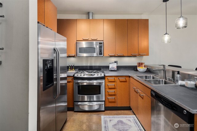 kitchen with decorative light fixtures, appliances with stainless steel finishes, and sink