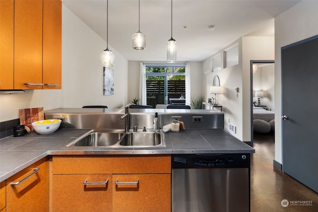 kitchen featuring hanging light fixtures, dishwasher, and sink