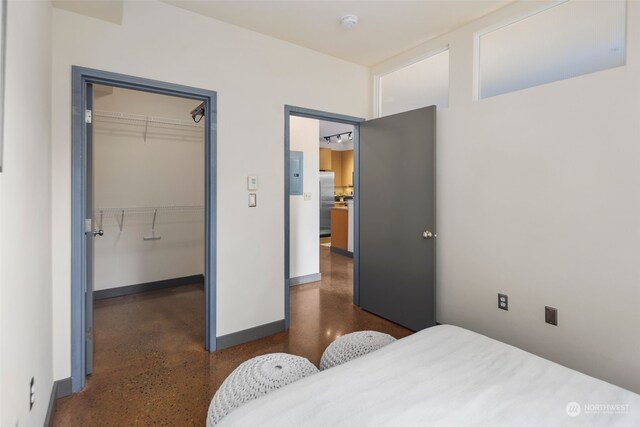 bedroom featuring stainless steel refrigerator and a closet