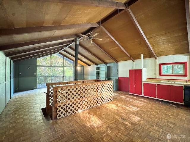 additional living space with lofted ceiling with beams, sink, ceiling fan, and dark parquet flooring