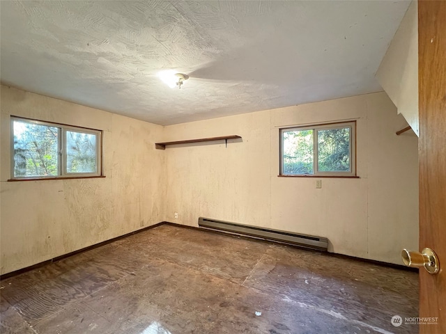 empty room featuring vaulted ceiling and a baseboard heating unit