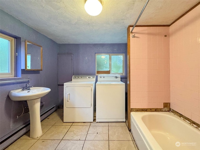 344 Dungeness Mdws, Sequim, WA 98382 - bathroom with washing machine and dryer, baseboard heating, tile patterned floors, a textured ceiling, and  shower combination