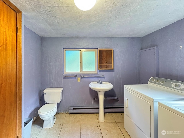 344 Dungeness Mdws, Sequim, WA 98382 - half bathroom featuring washer and clothes dryer, tile patterned flooring, toilet, a baseboard radiator, and a sink