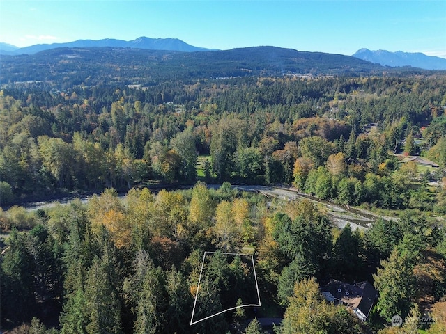 344 Dungeness Mdws, Sequim, WA 98382 - aerial view of property and surrounding area with a heavily wooded area, a mountain backdrop, and property boundaries highlighted
