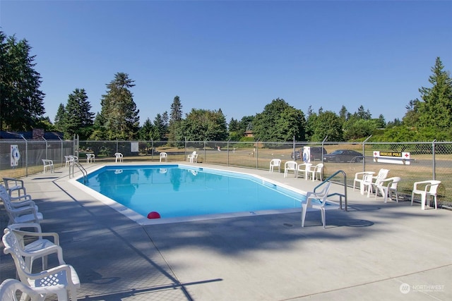 344 Dungeness Mdws, Sequim, WA 98382 - community pool featuring a patio area and view of scattered trees