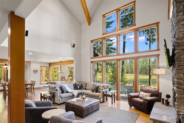 living room with a healthy amount of sunlight and high vaulted ceiling