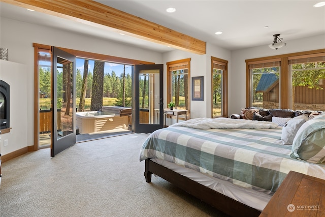 bedroom featuring carpet floors, beam ceiling, and access to exterior