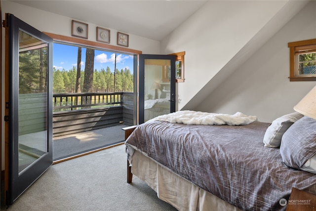 carpeted bedroom with access to outside and vaulted ceiling