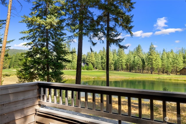 deck featuring a lawn and a water view