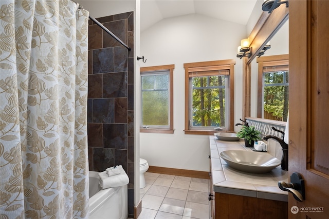 full bathroom with vanity, lofted ceiling, toilet, and a healthy amount of sunlight