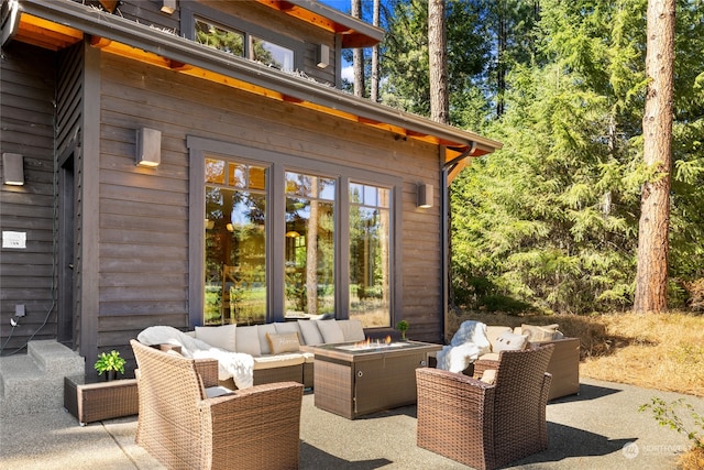 view of patio / terrace featuring an outdoor living space with a fire pit