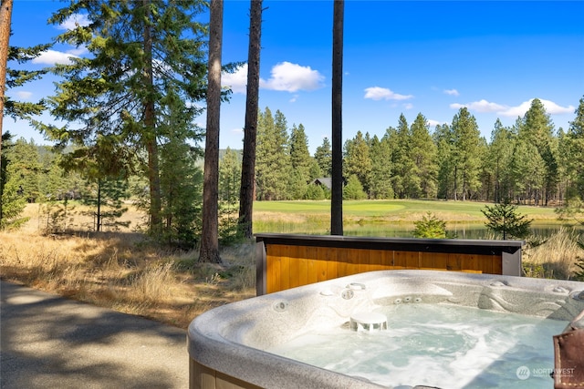 exterior space featuring a hot tub and a water view