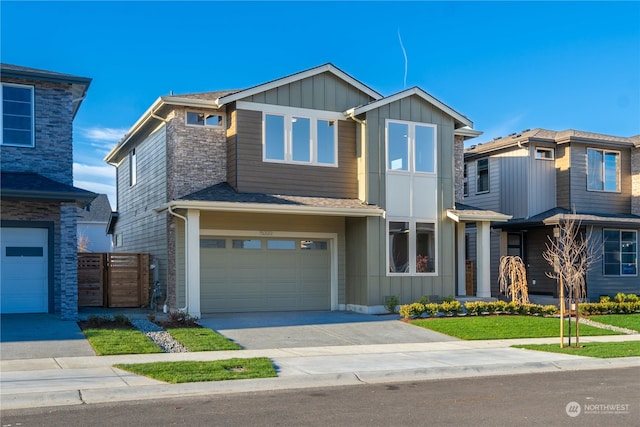 view of front of house with a garage and a front yard