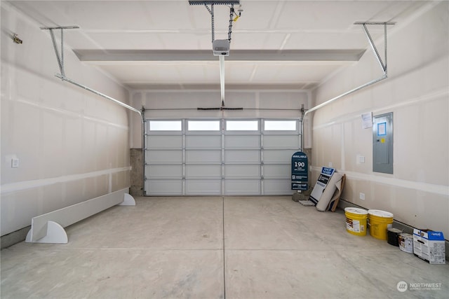 garage featuring electric panel and a garage door opener