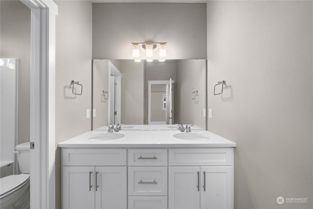 bathroom with toilet and vanity