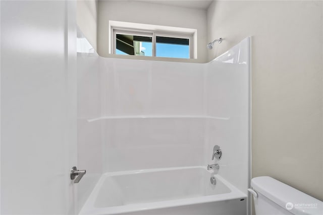 bathroom featuring shower / tub combination and toilet